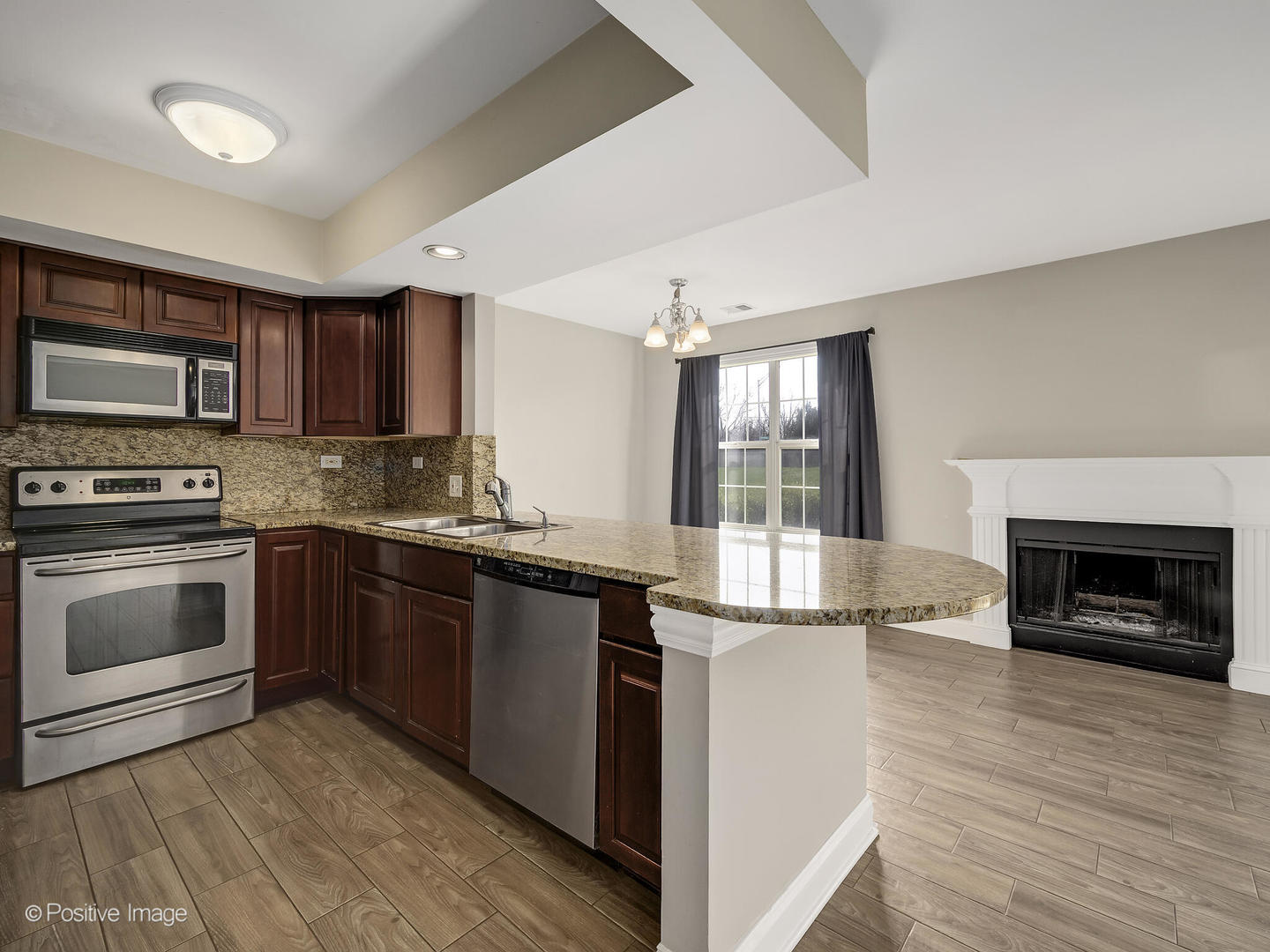 11 Foxcroft Road, Unit 115 Naperville, IL 60565 - Photo 7 of 17 a kitchen with granite countertop a stove top oven and oven