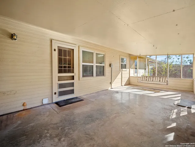 a bathroom with a granite countertop sink a large mirror and a toilet