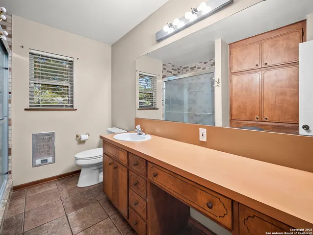 a bathroom with a shower and a sink