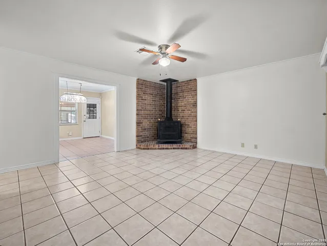 a view of an empty room with window and cabinet