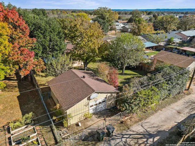 an aerial view of a house with a yard