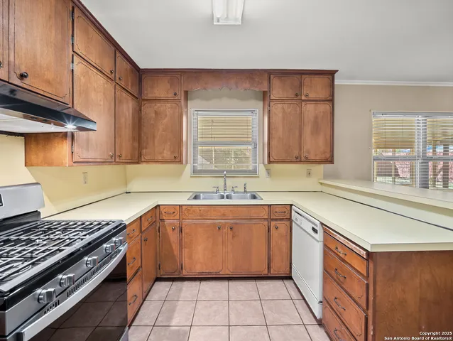 a kitchen with a sink stove and cabinets