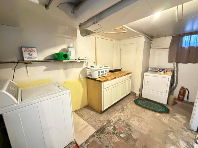 156 D Street Helper, UT 84526 - Photo 23 of 24 Laundry area featuring cabinet space and unfinished concrete floors