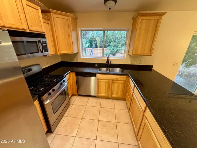 an empty room with windows and ceiling fan