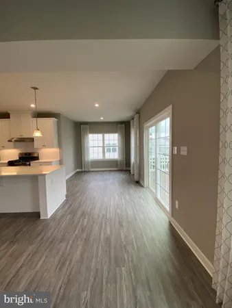 a view of kitchen and hall with wooden floor