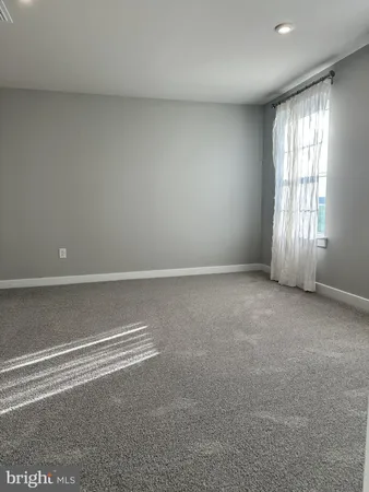 an empty room with windows and entrance