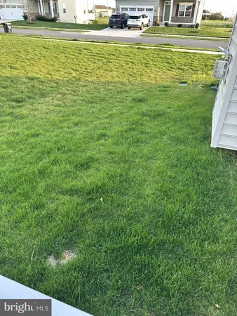 a view of a big house with a big yard