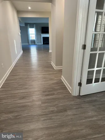 a view of a hallway with wooden floor and fire place