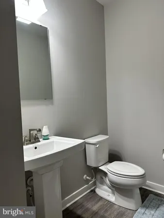 a white toilet sitting next to a bathroom sink