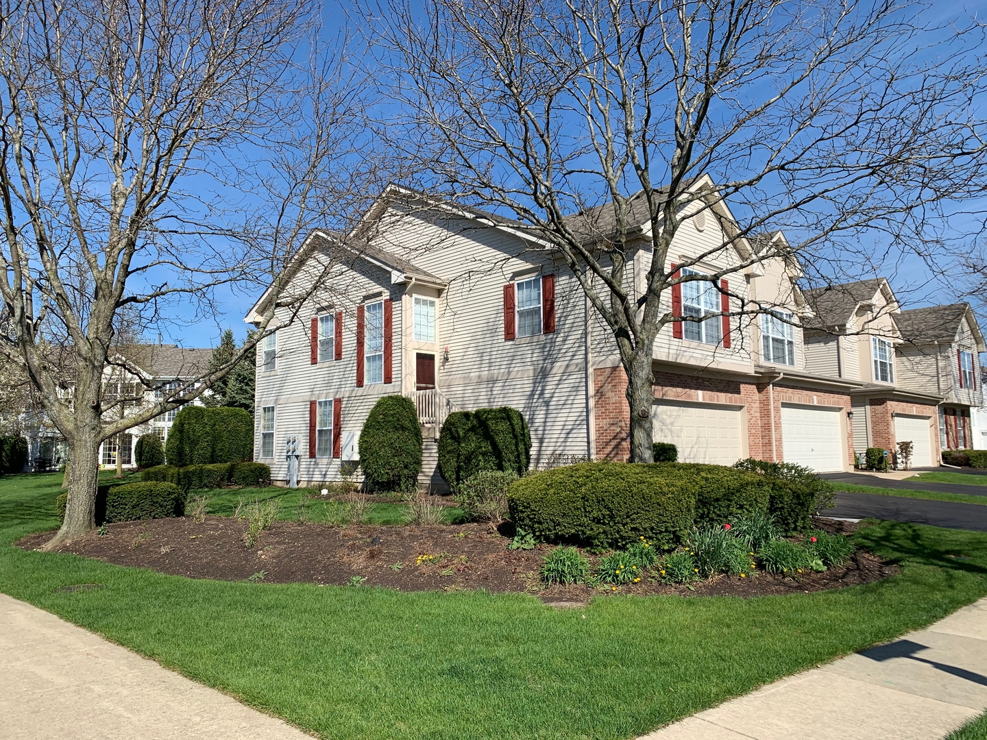 703 Riding Lane, Unit 703 St. Charles, IL 60174 - Photo 2 of 22 a front view of a house with a yard
