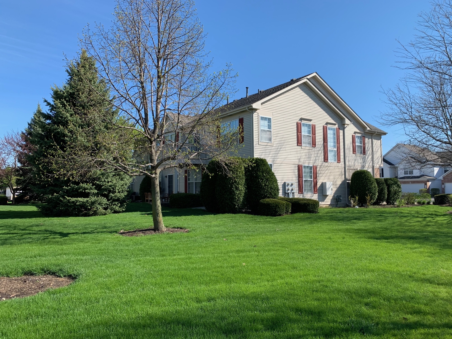 703 Riding Lane, Unit 703 St. Charles, IL 60174 - Photo 3 of 22 a view of a house with a yard