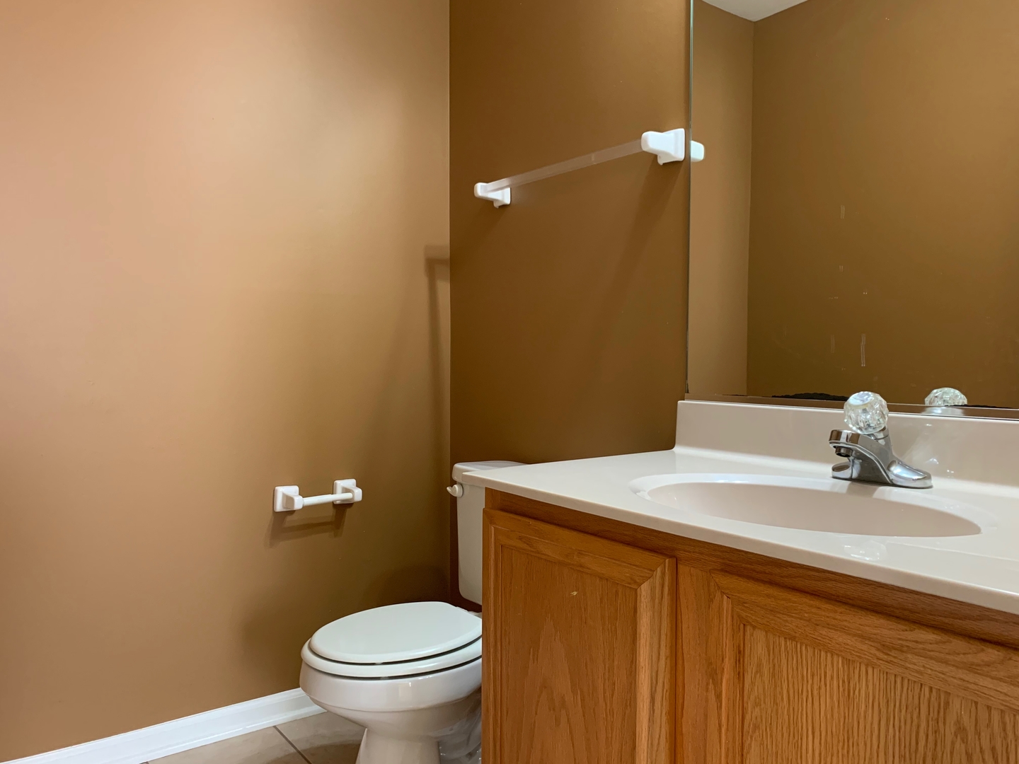 703 Riding Lane, Unit 703 St. Charles, IL 60174 - Photo 21 of 22 a bathroom with a sink a toilet and a mirror