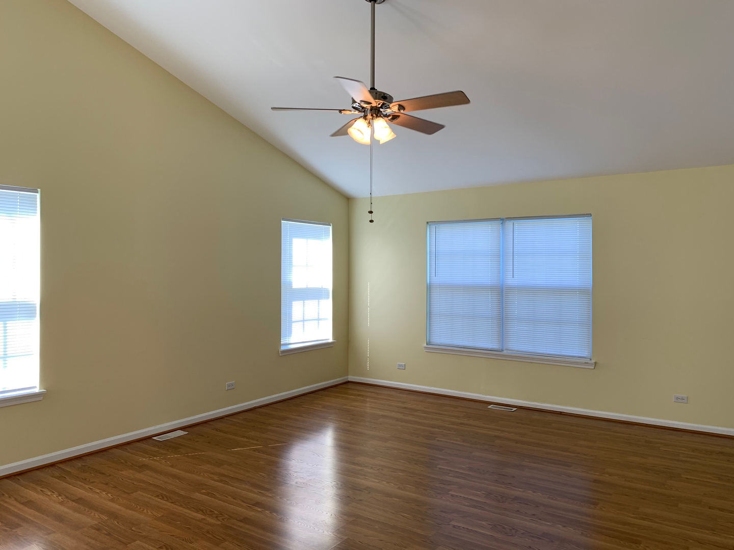 703 Riding Lane, Unit 703 St. Charles, IL 60174 - Photo 8 of 22 a view of a room with window chandelier fan and wooden floor