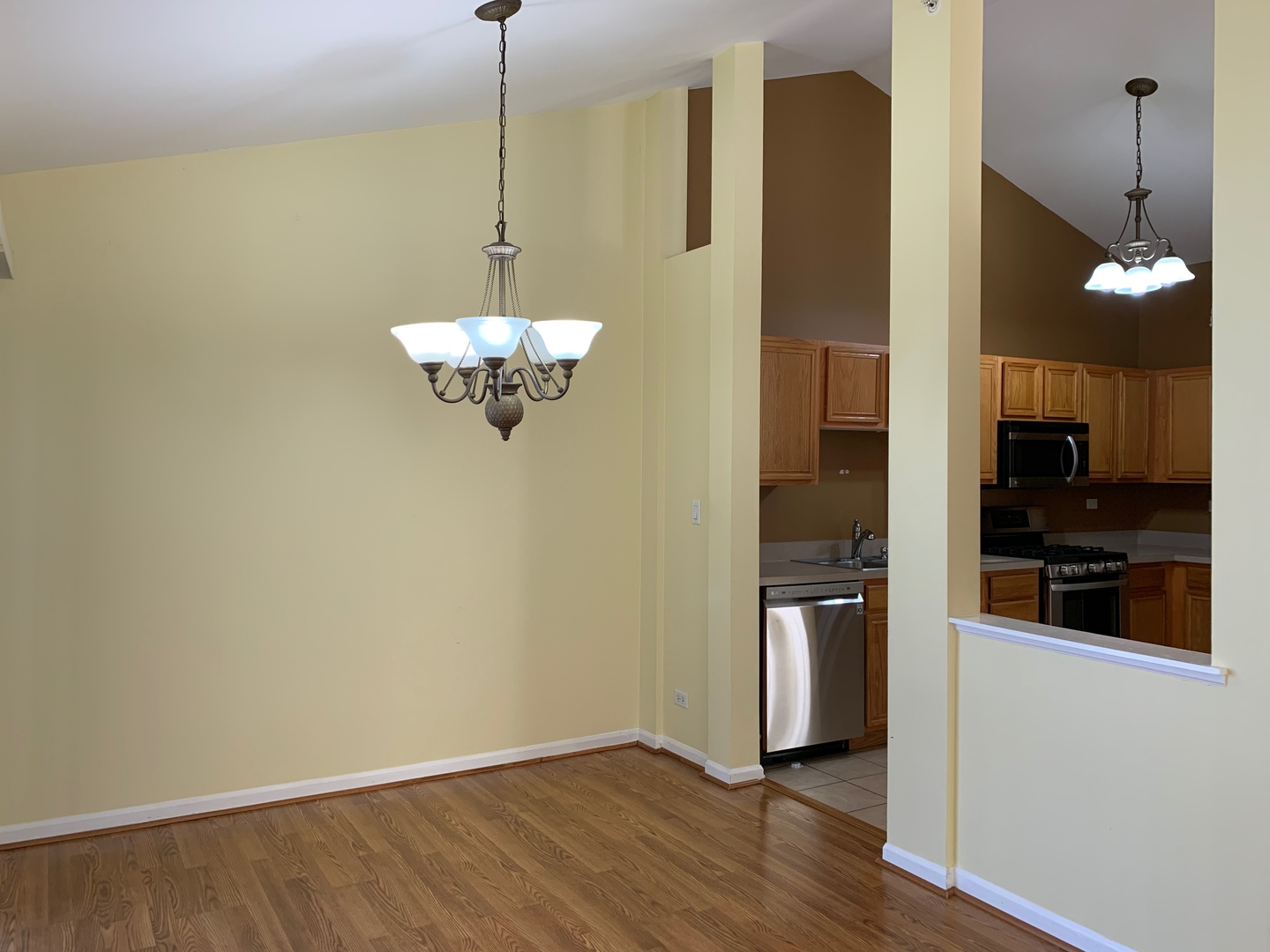 703 Riding Lane, Unit 703 St. Charles, IL 60174 - Photo 9 of 22 a view of a kitchen with stainless steel appliances granite countertop cabinets and a wooden floor