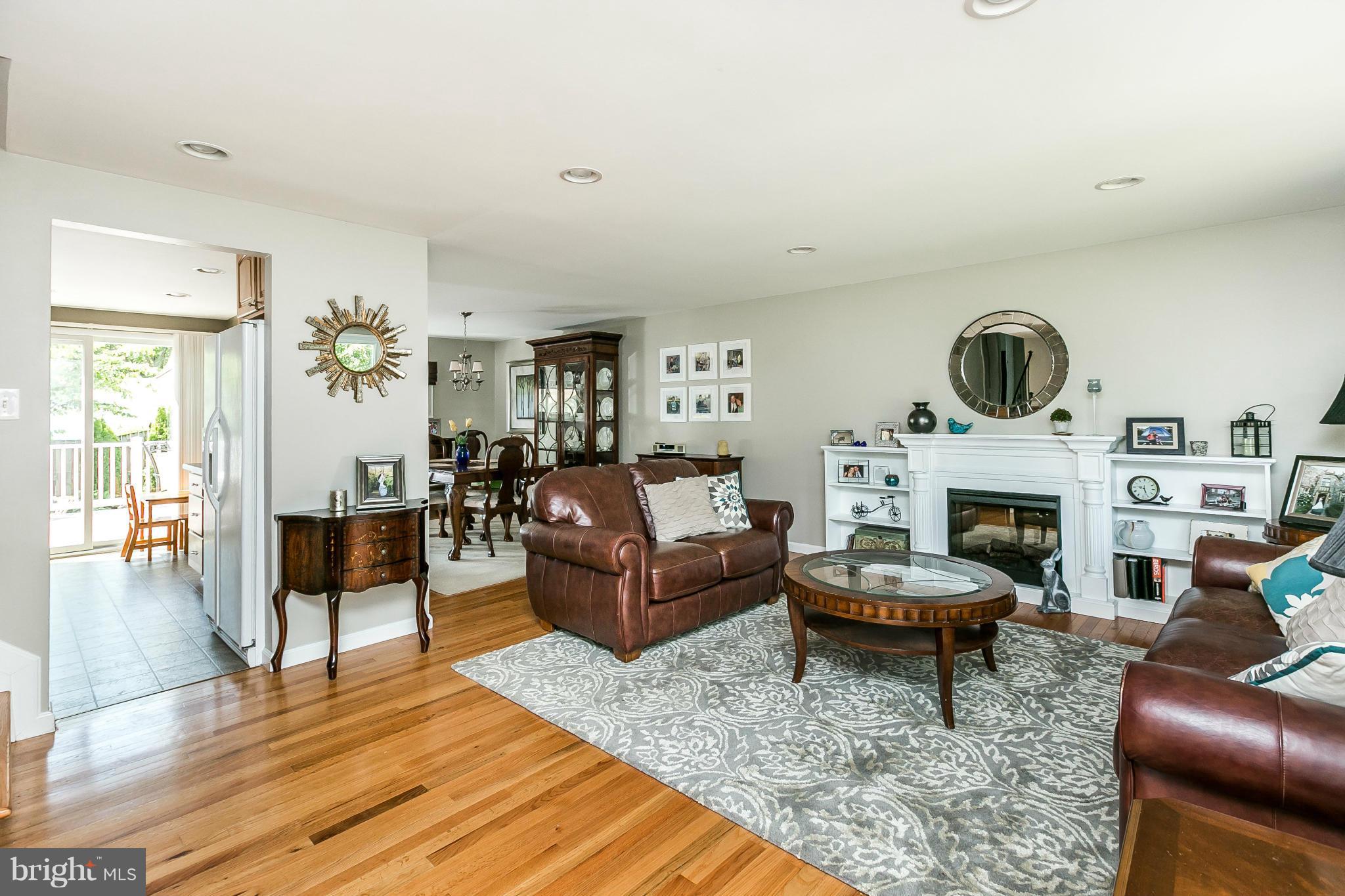 1901 Logwind Road Catonsville, MD 21228 - Photo 3 of 30 a living room with furniture a fireplace and wooden floor