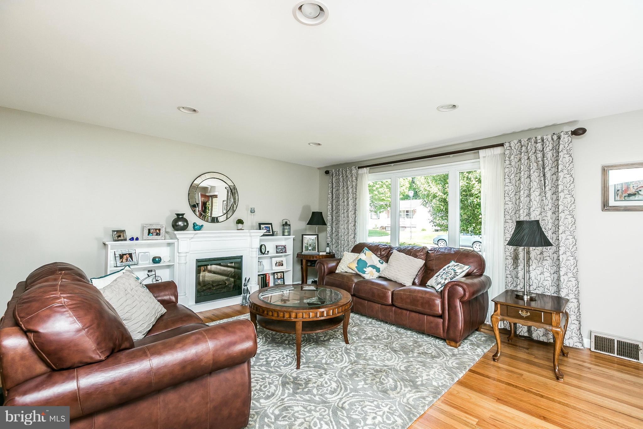 1901 Logwind Road Catonsville, MD 21228 - Photo 4 of 30 a living room with furniture and a fireplace