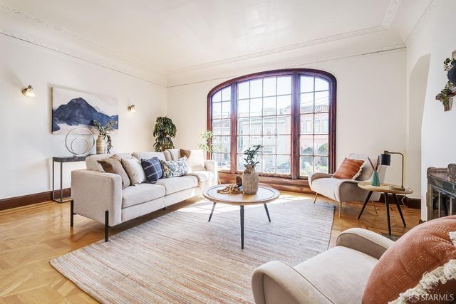 a living room with furniture and a window with outer view