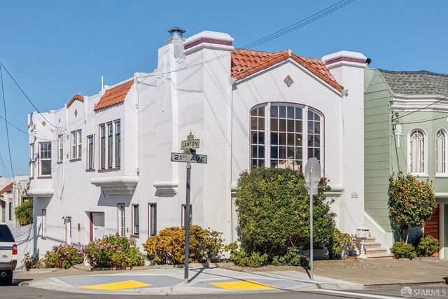 a view of a white building among the street
