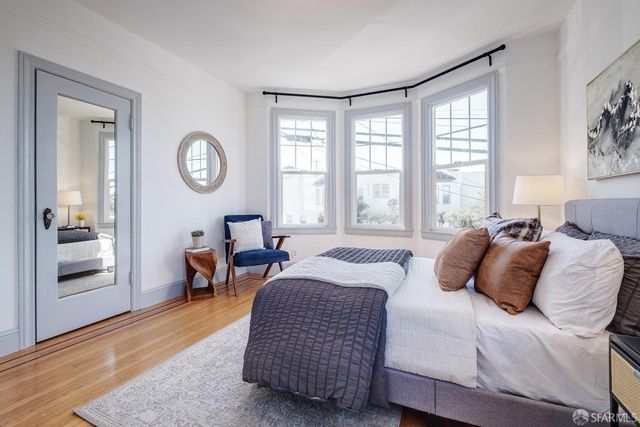 a bedroom with bed and window
