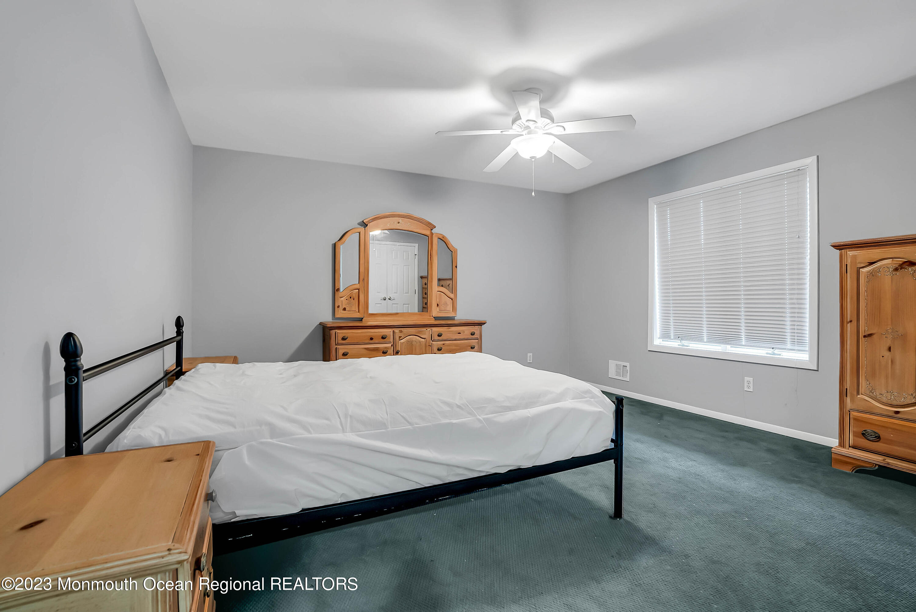 200 Parker Road West Long Branch, NJ 07764 - Photo 31 of 50 a bedroom with a bed and a chandelier
