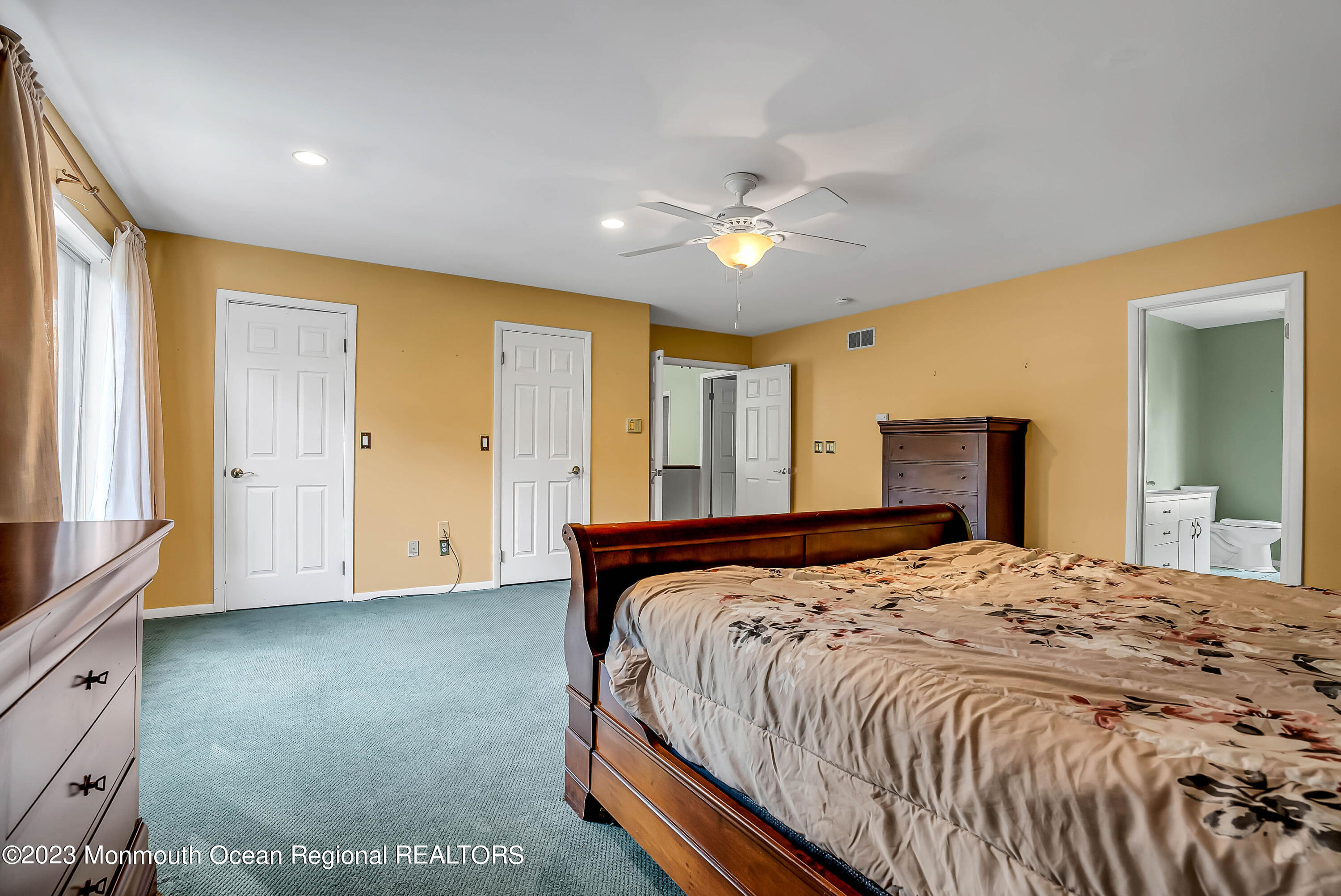 200 Parker Road West Long Branch, NJ 07764 - Photo 37 of 50 a spacious bedroom with a large bed and a chandelier