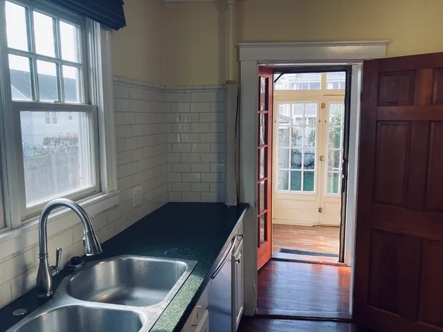 a kitchen with a sink a faucet a window and stainless steel appliances