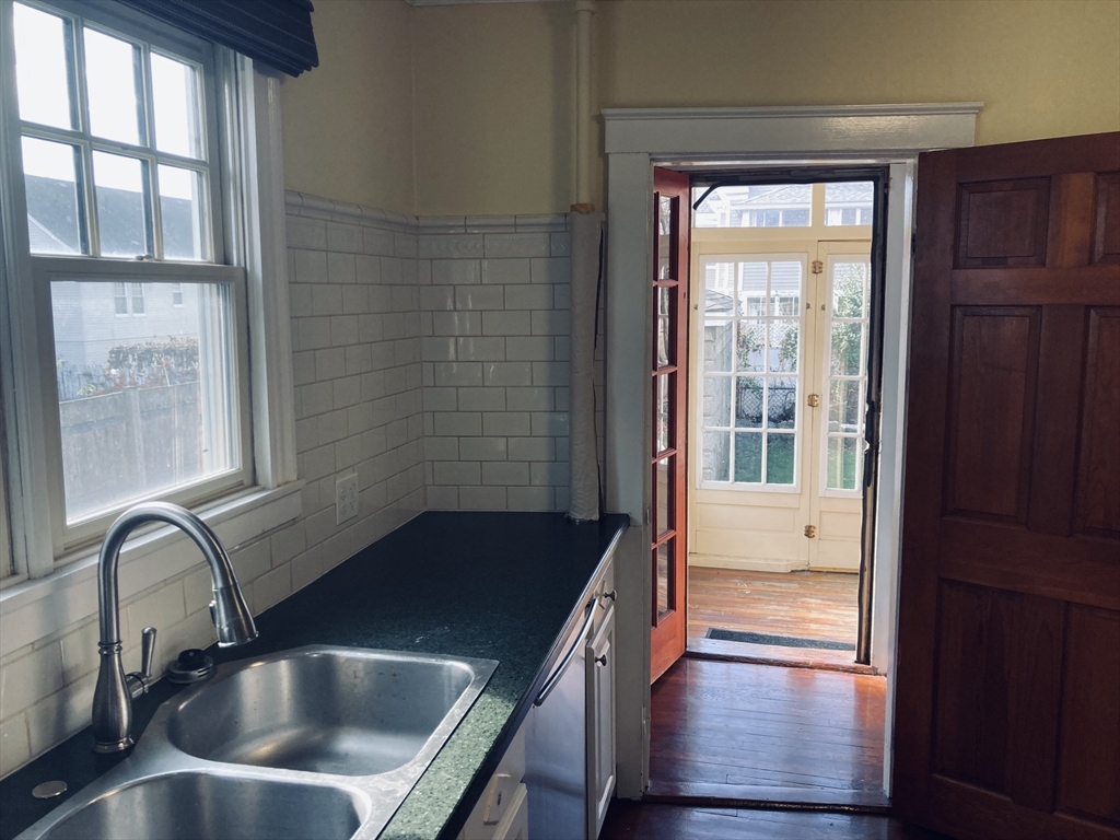 42 Alicia Road, Unit 1 Boston, MA 02124 - Photo 14 of 19 a kitchen with a sink a faucet a window and stainless steel appliances