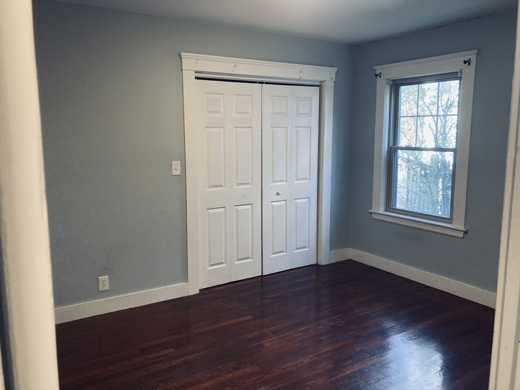 42 Alicia Road, Unit 1 Boston, MA 02124 - Photo 15 of 19 a view of an empty room with wooden floor and a window