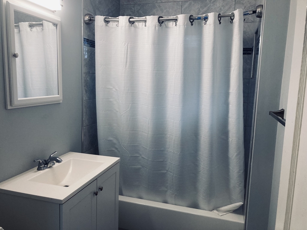 42 Alicia Road, Unit 1 Boston, MA 02124 - Photo 18 of 19 a bathroom with a sink and a mirror