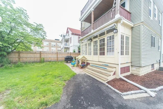 a view of a house with a yard and sitting area