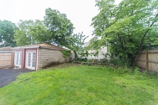 42 Alicia Road, Unit 1 Boston, MA 02124 - Photo 9 of 19 a backyard of a house with lots of plants and large tree