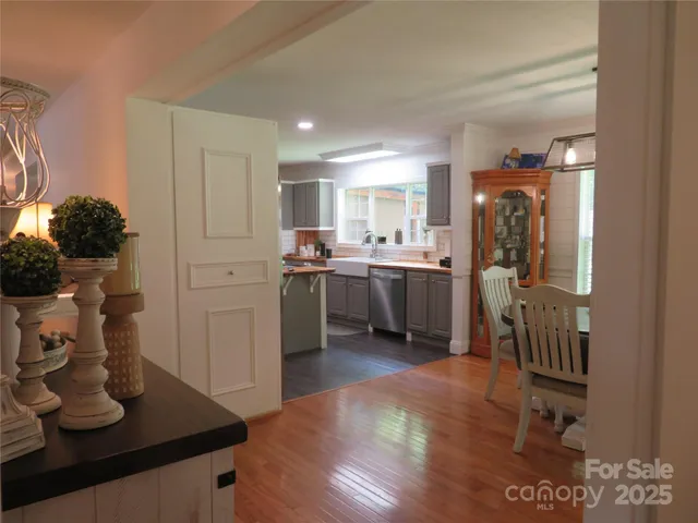 a kitchen with stainless steel appliances granite countertop a sink dishwasher stove and refrigerator
