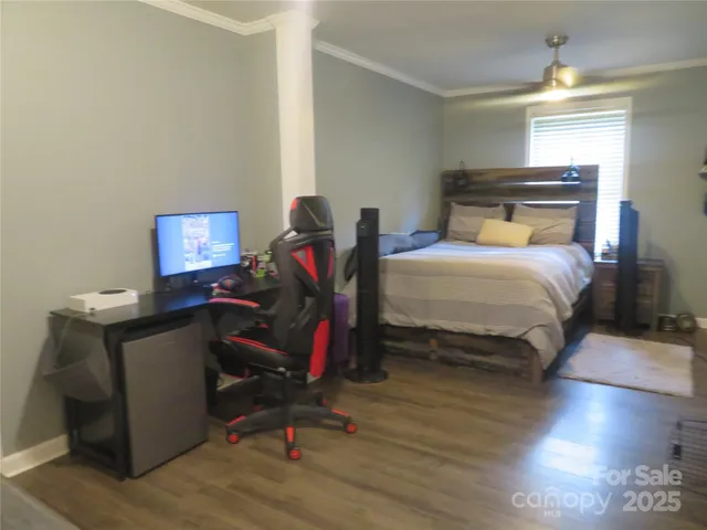 a bedroom with a bed and a desk in it