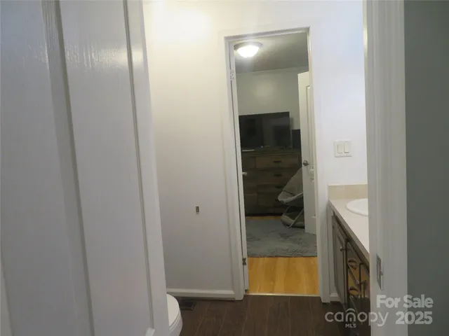 a bathroom with a glass door and a vanity