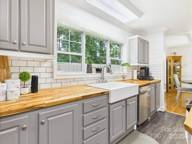 a kitchen with sink and large window
