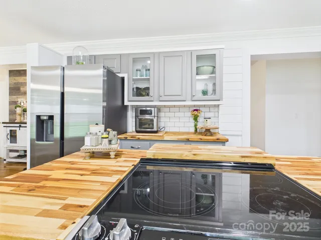 a kitchen with kitchen island a counter top space a sink appliances and cabinets