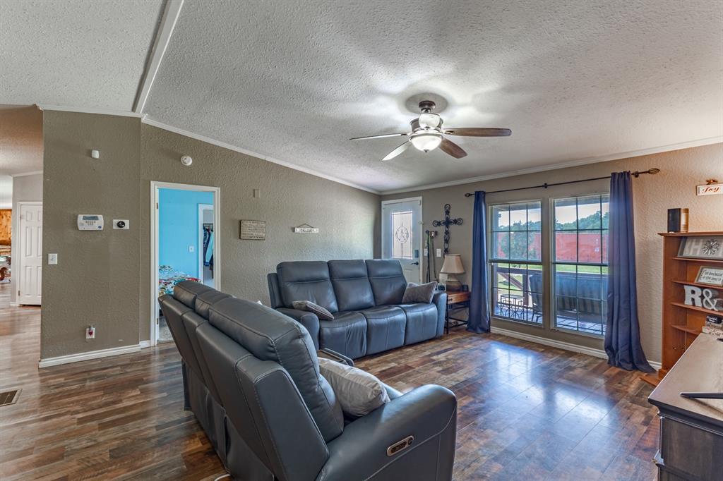 75 Southern Road Mineral Wells, TX 76067 - Photo 11 of 31 a living room with furniture and a chandelier