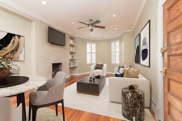 a living room with furniture a fireplace and a flat screen tv
