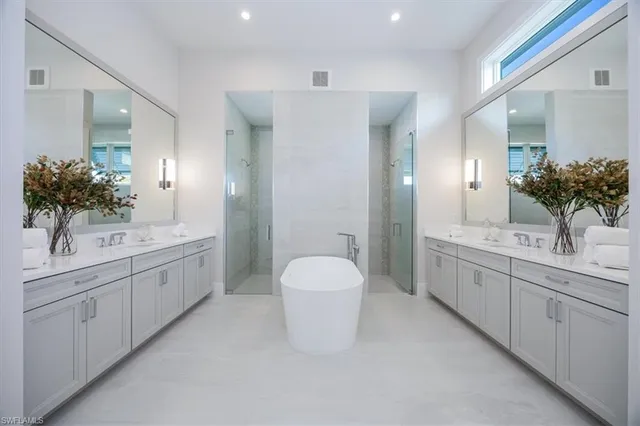 a spacious bathroom with a double vanity sink mirror and toilet