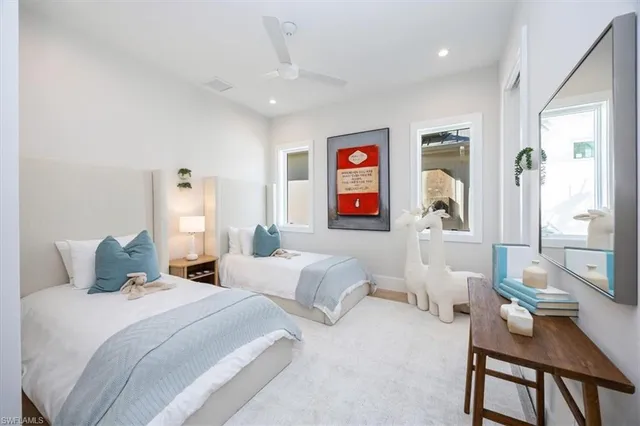 a bedroom with two beds and a table