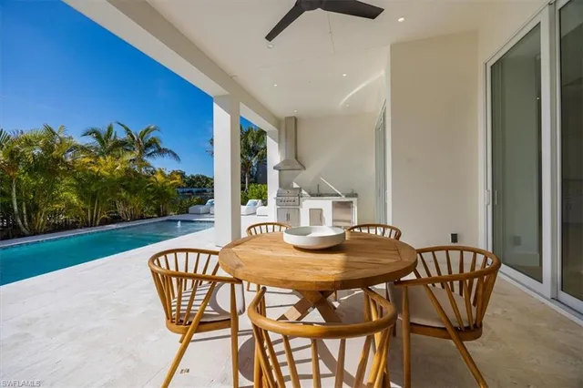 a view of an outside dining space with furniture and garden