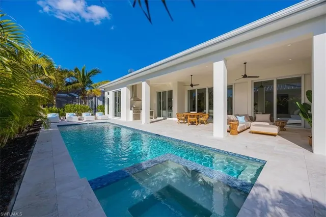a view of a swimming pool with outdoor seating