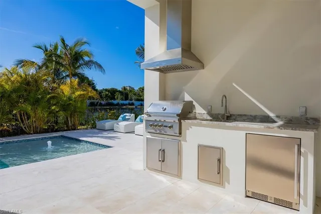 a kitchen with a stove a sink and a microwave