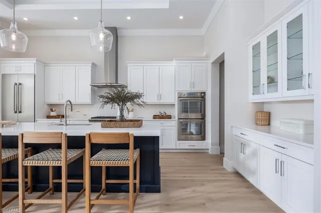 a large kitchen with a table and chairs