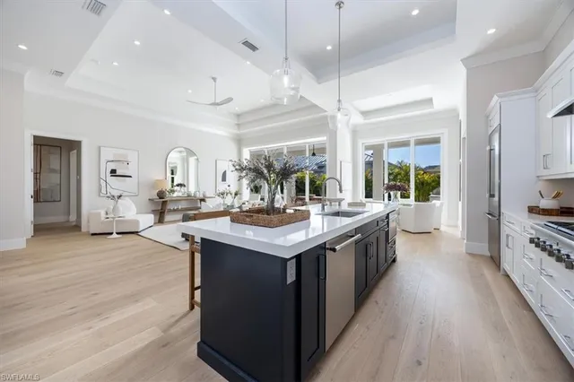 a kitchen with stainless steel appliances granite countertop a sink and a stove