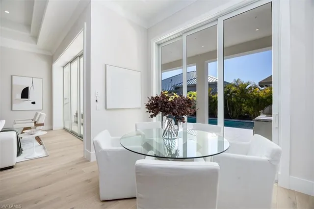 a dining room with furniture and wooden floor