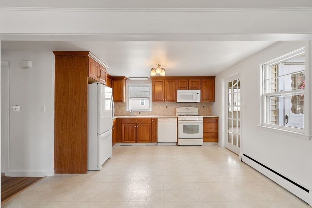 21 Desoto Road Boston, MA 02132 - Photo 12 of 37 a kitchen with stainless steel appliances a refrigerator and cabinets