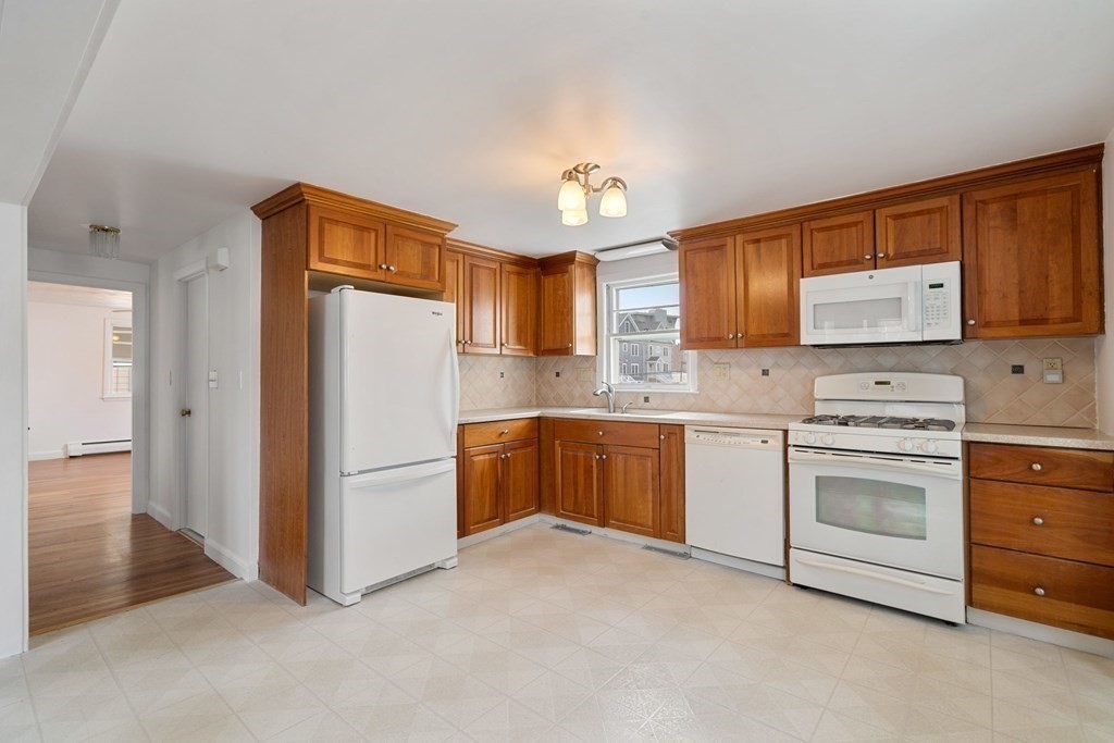 21 Desoto Road Boston, MA 02132 - Photo 13 of 37 a kitchen with a refrigerator sink and cabinets