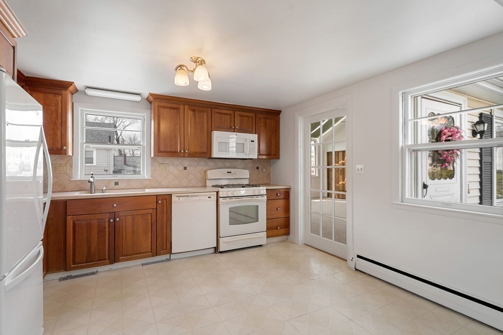 21 Desoto Road Boston, MA 02132 - Photo 14 of 37 a kitchen with granite countertop a sink cabinets stainless steel appliances and a window
