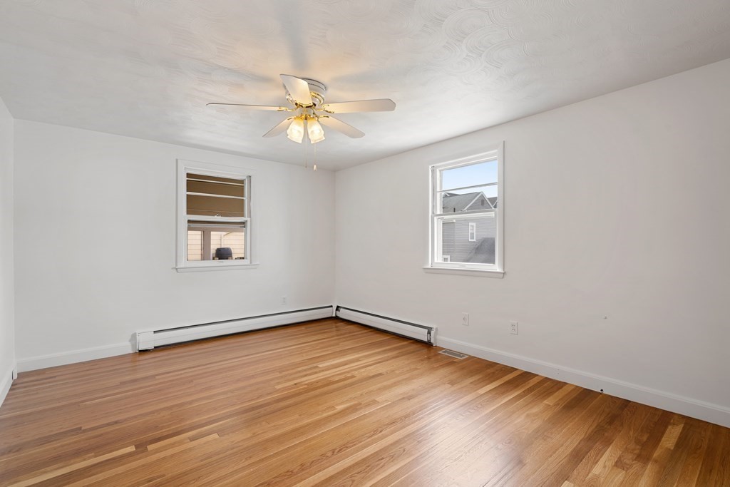 21 Desoto Road Boston, MA 02132 - Photo 20 of 37 a view of an empty room with wooden floor and a window